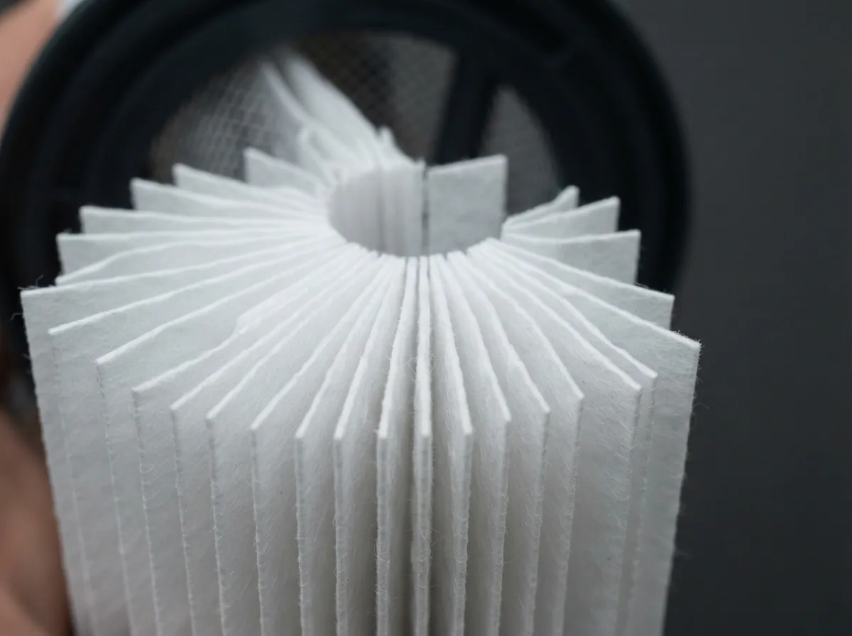 A detailed cross-section view of the pleated filter paper inside a Type D cartridge.
